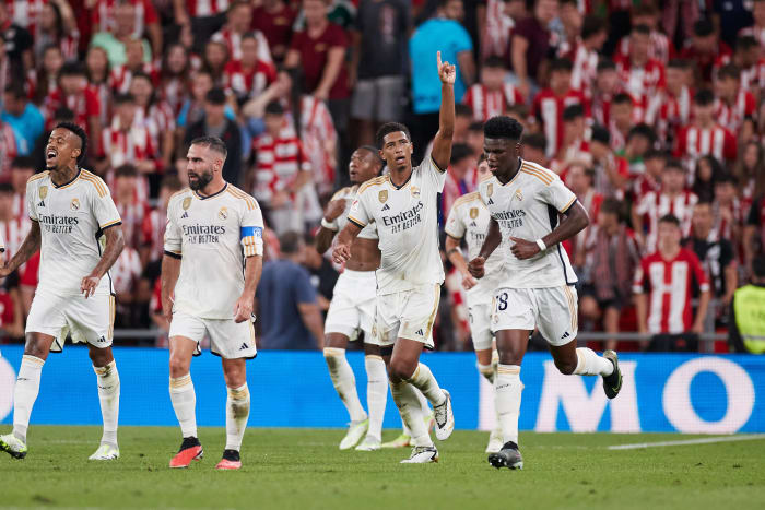 Jude Bellingham pictured raising his left arm to celebrate after scoring his first La Liga goal for Real Madrid in a 2-0 win at Athletic Bilbao in August 2023